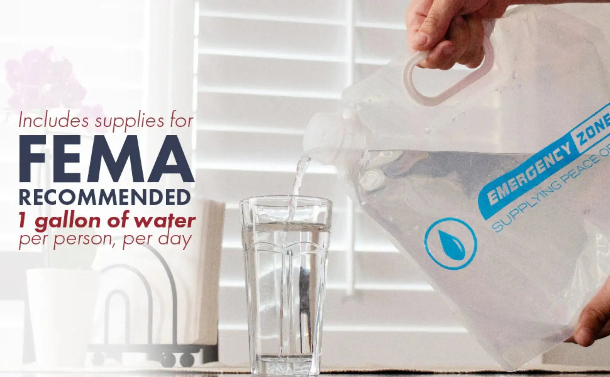 A person pouring water from a translucent white emergency water storage container labeled 'EMERGENCY ZONE SUPPLYING PURE WATER' into a clear glass. Text on the left reads 'Includes supplies for FEMA RECOMMENDED 1 gallon of water per person, per day' against a bright window background.