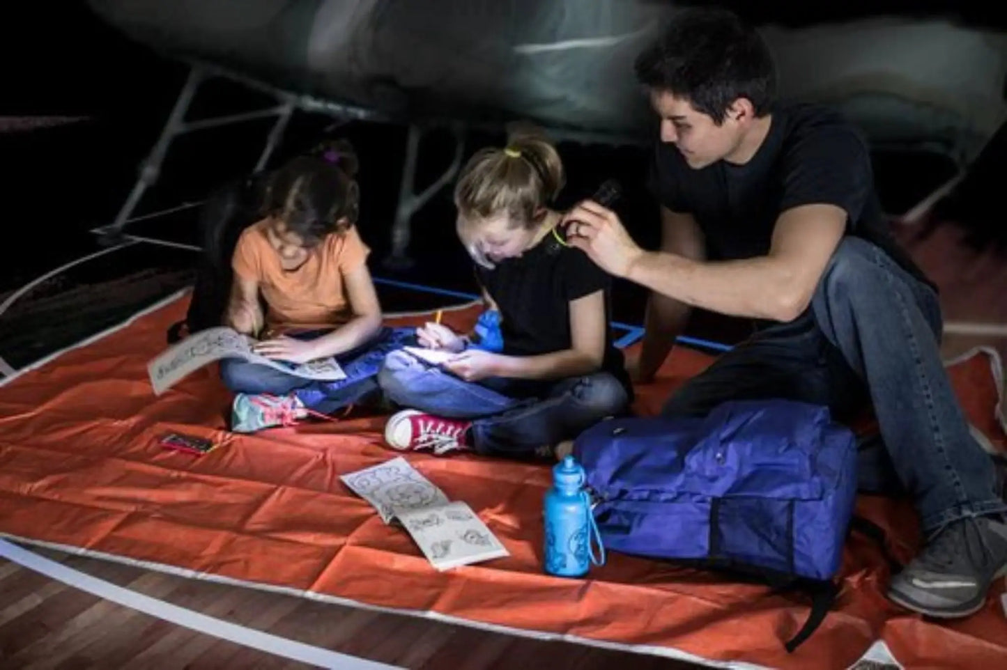 childrens survival backpack shown in lifestyle image with kids using contents