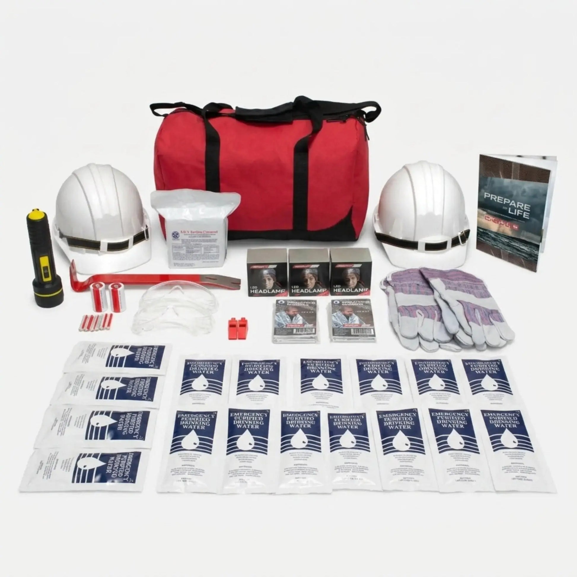 Emergency preparedness kit with red bag, helmets, water packets, and other supplies on a white background