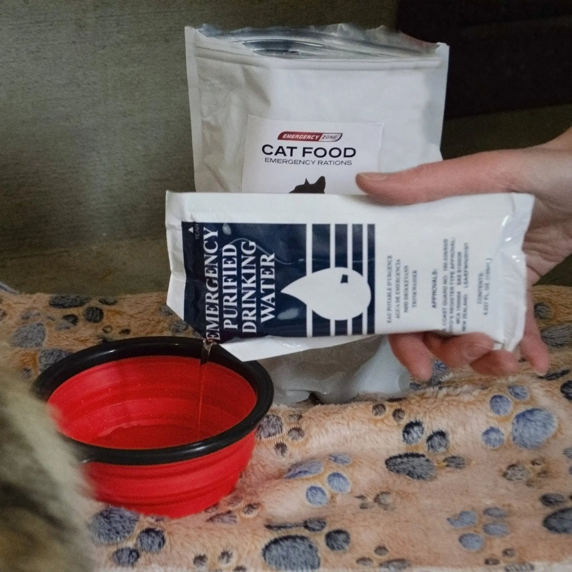 person holding emergency drinking water included for cats