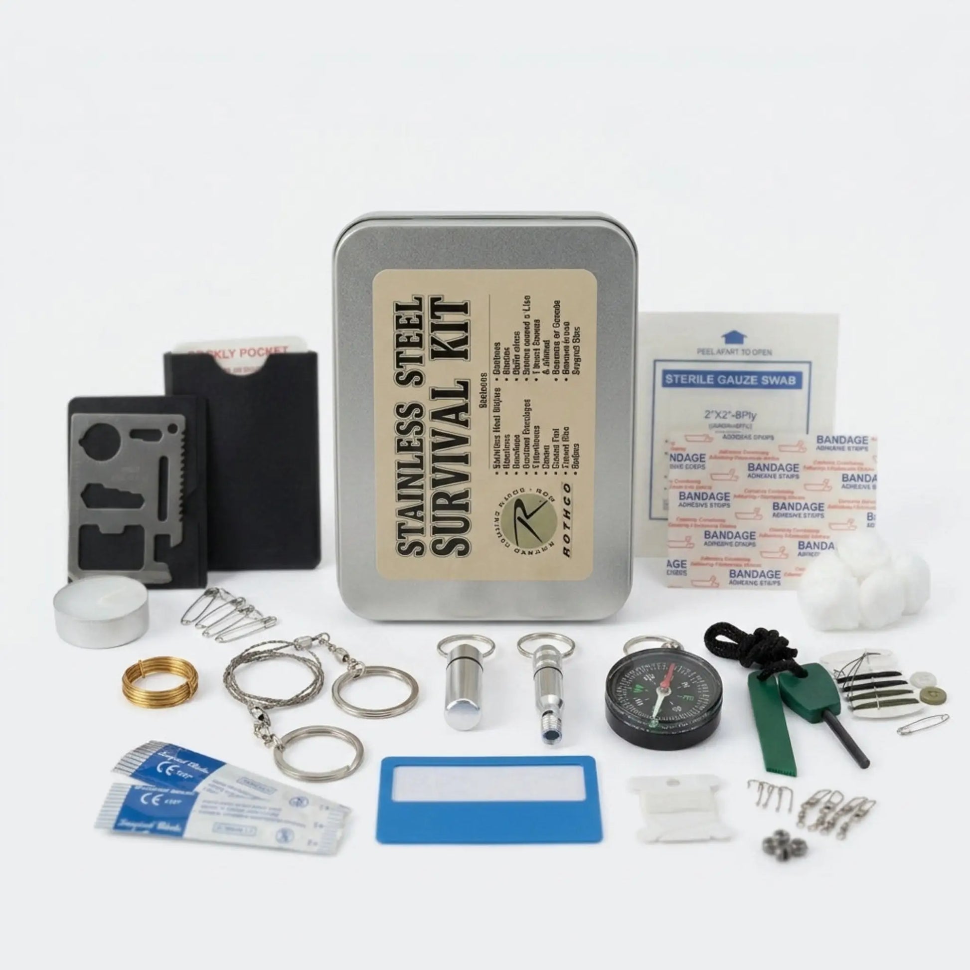 A stainless steel survival kit arranged on a white background, including a metal tin labeled 'STAINLESS STEEL SURVIVAL KIT,' a multi-tool, compass, gloves, bandages, keys, screws, and other emergency preparedness tools.