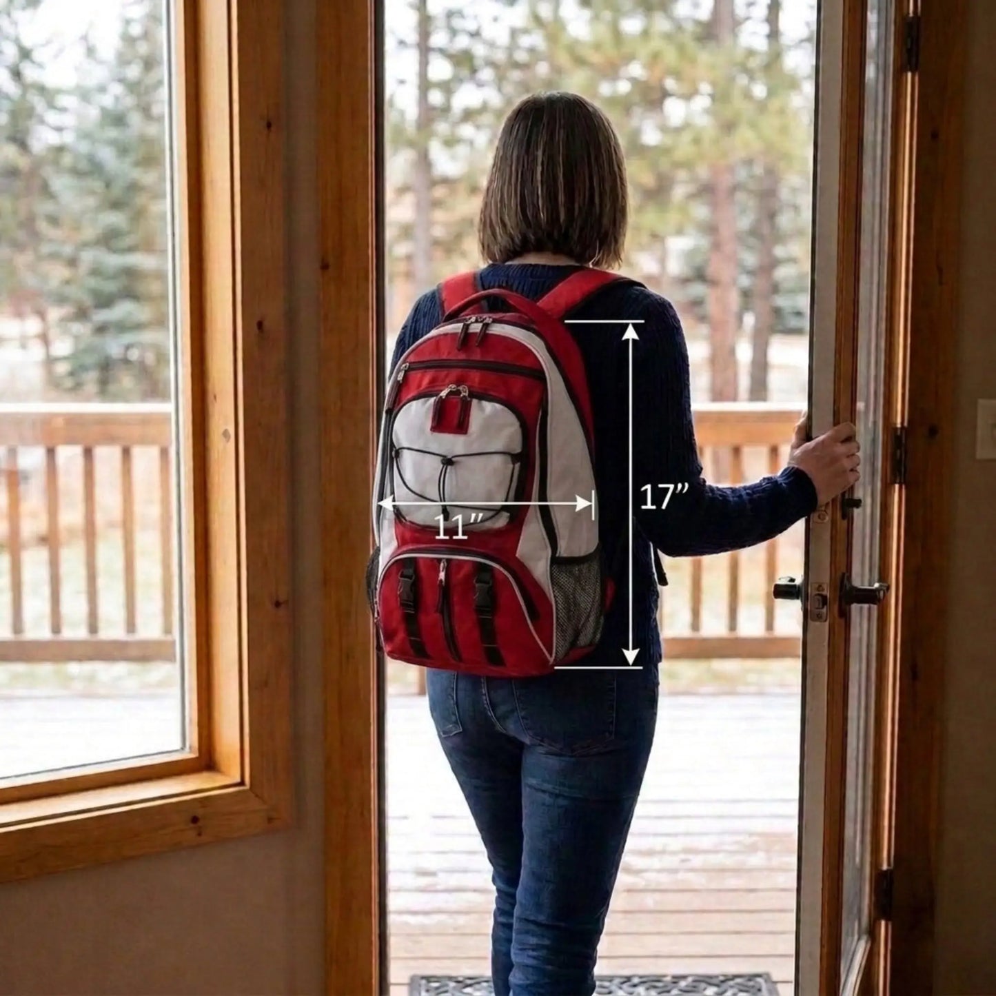 A woman viewed from behind stands in a doorway wearing a red, white, and gray backpack. White measurement lines and text indicate the backpack's dimensions: 17 inches tall and 11 inches wide.